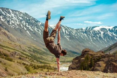 Man making acrobatic trick on hand upside down Stock Photos