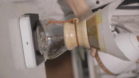 Man making alternative specialty filter coffee in pour over, brewing, minimal Stock Footage 221261801