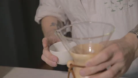 Man making alternative specialty filter coffee in pour over, brewing, minimal Stock Footage 221261829