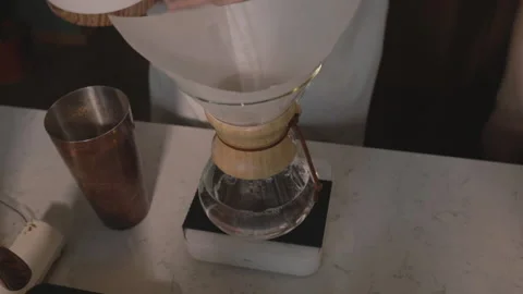 Man making alternative specialty filter coffee in pour over, brewing, minimal Stock Footage 221261853