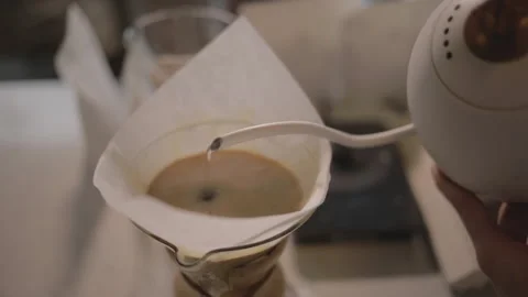 Man making alternative specialty filter coffee in pour over, brewing, minimal Stock Footage 221261922