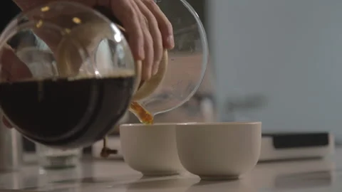 Man making alternative specialty filter coffee in pour over, brewing, minimal Stock Footage 221262038
