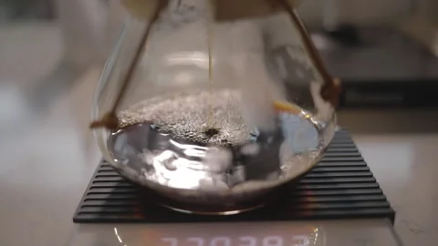 Man making alternative specialty filter coffee in pour over, brewing, minimal Stock Footage 234939231