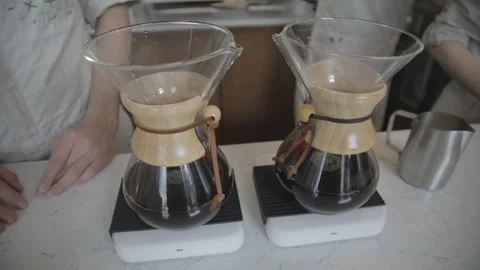 Man making alternative specialty filter coffee in pour over, brewing, minimal Stock Footage 241189313