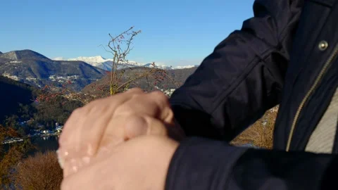 Man Making and Throwing a Snow Ball and Joy Mountain View 動画素材 194011805