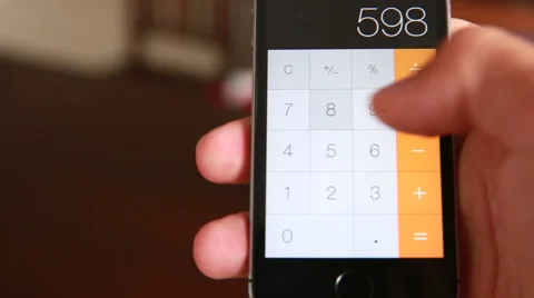 Man Is Making Arithmetic Operation With The Calculator Of The Smartphone Stock Footage 55550081