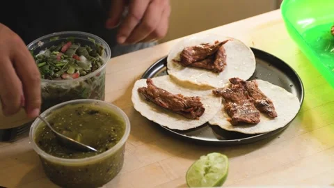Man Making Arrachera Steak Tacos Topped Off With Green Salsa And Nopales Stock Footage 341559855