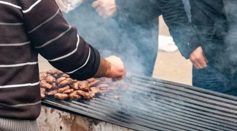 A man making barbeque with Camel meat. Stock Photos