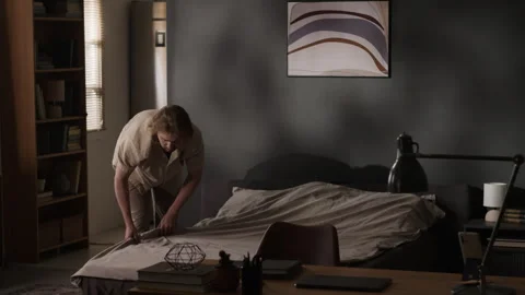 Man Making Bed in Bedroom during Daily Morning Routine Stock Footage 345514916