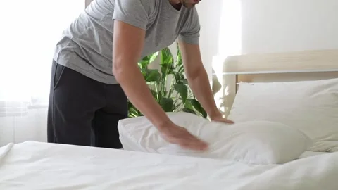 Man making bed early in the morning. Stock Footage 233266574