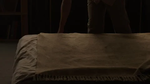 Man Making Bed by Smoothing Blanket for Morning Routine Stock Footage 345512415