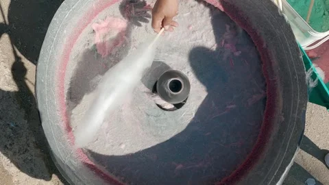 Man making a big pink sugar cloud candy at a fair stall Stock Footage 333722859