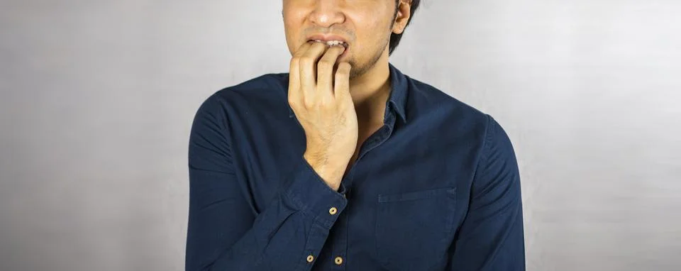Man making bite nail gesture Stock Photos