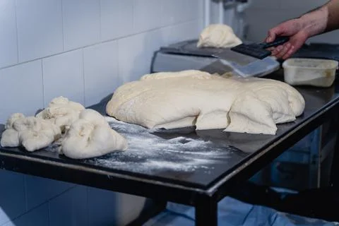 A man is making bread on a table Stock Photos