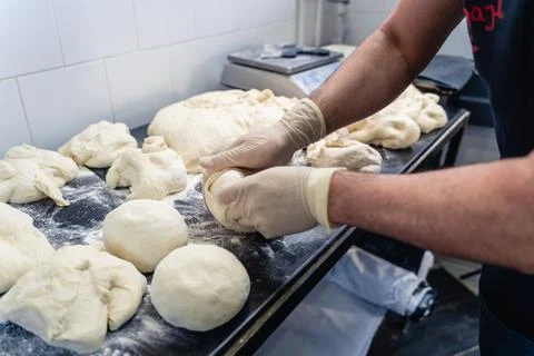A man is making bread on a table Stock Photos