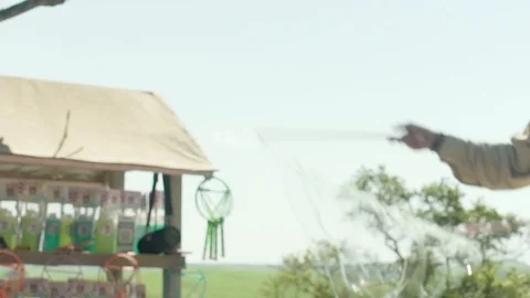 Man Making Bubbles in Public Stock Footage 106556541