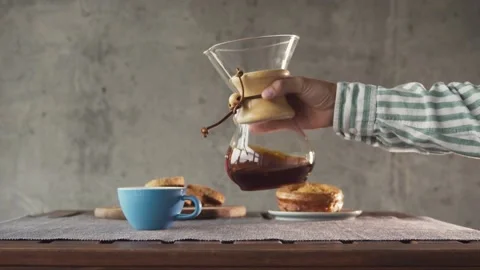 Man making coffee barista style at home. Chemex filter drip coffee served with Stock Footage 141903546