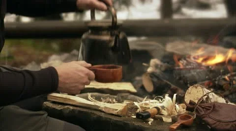 A man making coffee over a camp fire Stock Footage 11315518