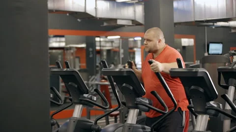 Man making cool down training on orbitrek Stock Footage 109057913