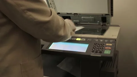 Man making copies  in the office with gloves to protect from coronavirus Stock Footage 130455399