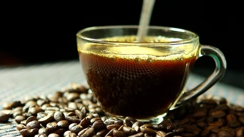 Man making a cup of coffee with coffee beans background, close up in studio Stock Footage 103034437