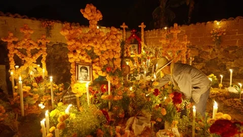 MAN MAKING A DAY OF THE DEATH ALTAR IN AROCUTIN, NEAR PATZCUARO LAKE Stock Footage 317747727