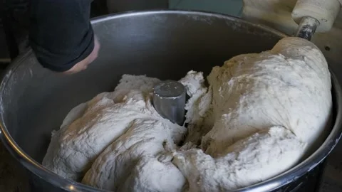 Man making dough in dough kneading machine Stock Footage 234914436