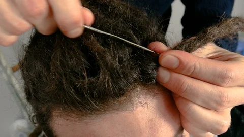 A man making dreads with a needle Video stock 86405371