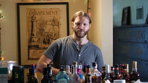 Man making drinks behind bar Stock Footage 154761940