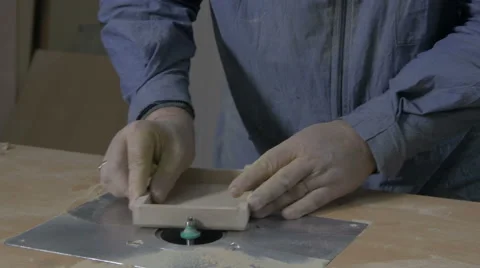 Man making edges on box with electric grinder in workshop, close up, tilt down. Stock Footage 57749186
