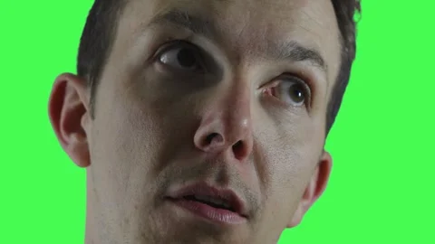 Man making exaggerated expression of disbelief and eye roll on green screen Stock Footage 309856851