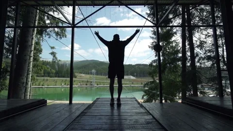 Man making exercises in slow motion on a viewing mountains spot Stock Footage 200498098