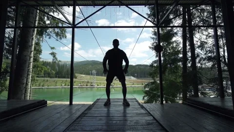 Man making exercises in slow motion on a viewing mountains spot Stock Footage 200498102