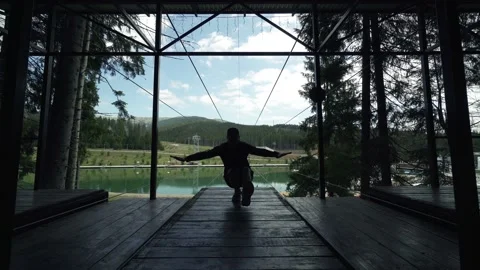 Man making exercises on a viewing mountains spot Stock Footage 200498295