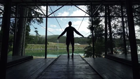 Man making exercises on a viewing mountains spot Stock Footage 200499050