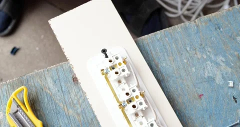 Man making an extension cord socket Stock Footage 142931241