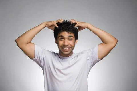 Man making a face with his hands in hair Fotos Stock