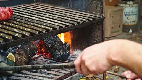 Man Making Fire for Argentine Barbecue Видео 132083089