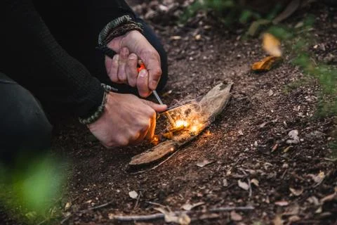 Man making fire with tinder polypore fungus in a forest Stock Photos
