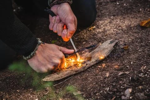 Man making fire with tinder polypore fungus in a forest Stock Photos