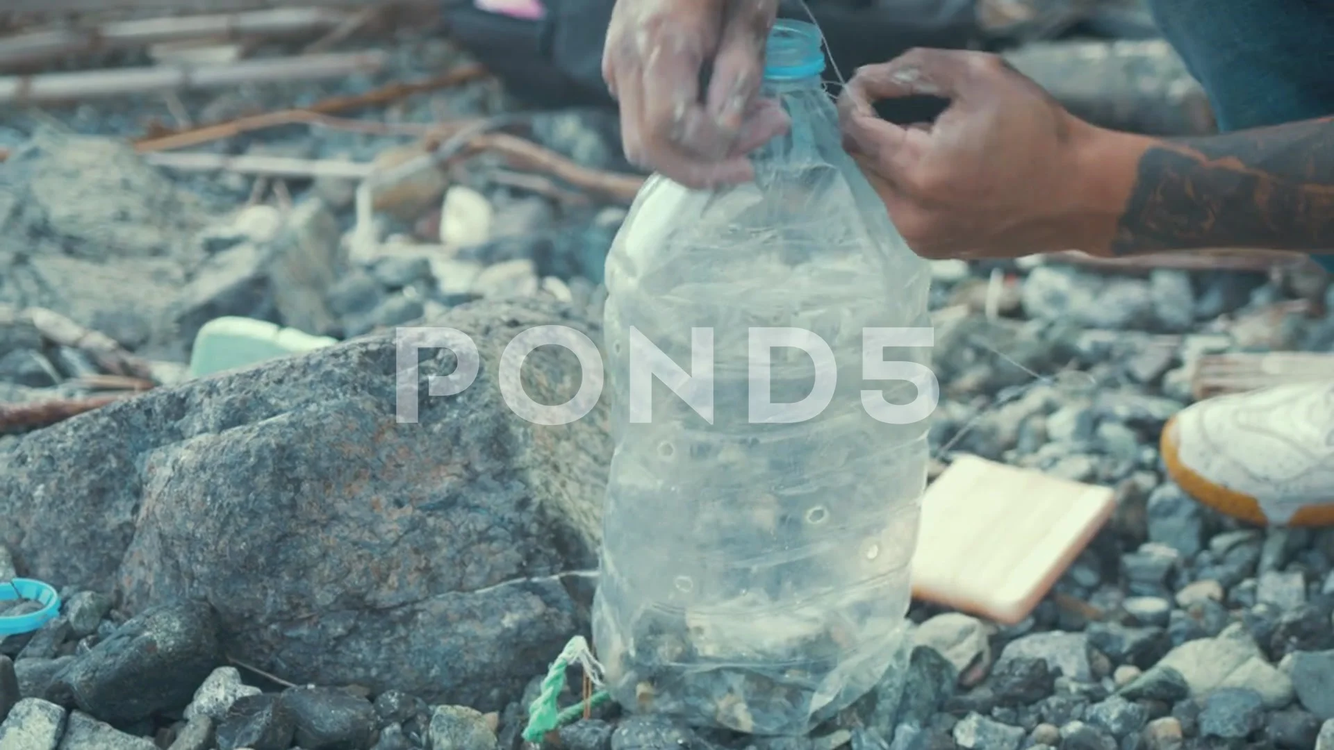 Man making fish trap recycling plastic b, Stock Video