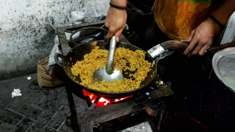 Man making fried rice using a traditional Indonesian stove Stock Footage 210462806