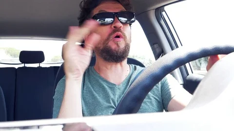 Man making funny crazy moves while driving super slow motion Stock Footage 77423921