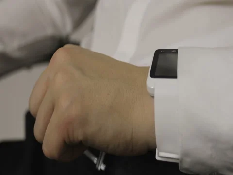 Man making gestures on a wearable smartwatch computer device. Stock Footage 73875749