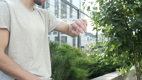 Man making gestures on a wearable smartwatch computer device, smart watch Stock Footage 94058675