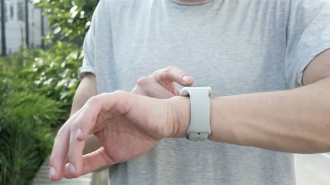 Man making gestures on a wearable smartwatch computer device, smart watch Stock Footage 94059292