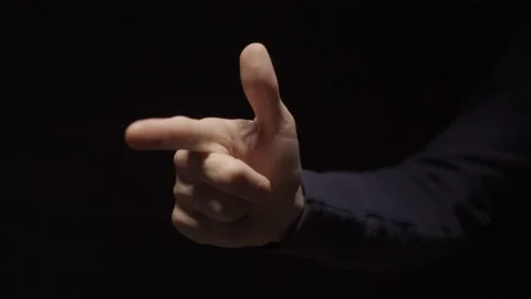 Man making a gun or firearm hand gesture and shoots three times and exits Stock Footage 132261253