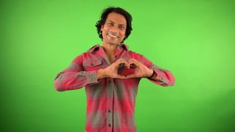 Man making heart shape with hands showing affection Stock Footage 297599207