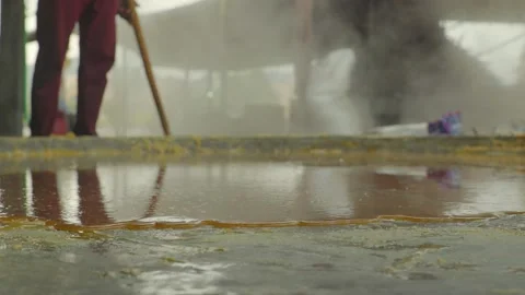 A Man making Jaggery in the plant Stock Footage 221888920