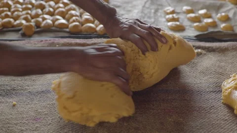 Man making jaggery into small pieces in factory Stock Footage 221889243